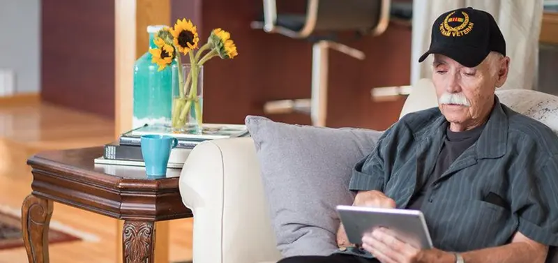 Veteran reading on tablet